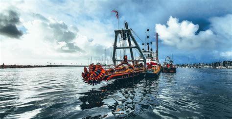 Mechanical dredging between marina docks